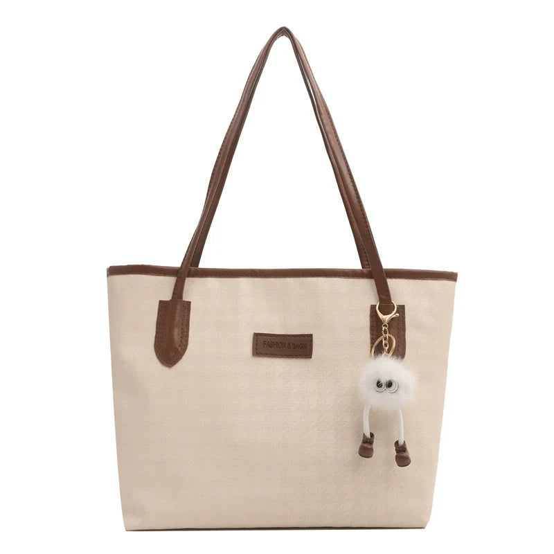 Cream Woven Canvas Tote Bag with Brown Leather Trim Dual Leather Straps Gold Logo Patch and Detachable White Pom Pom Keychain